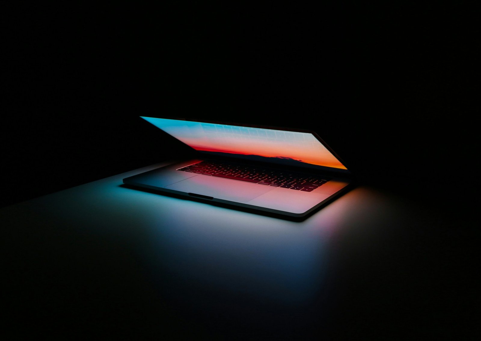 Dark professional analytics workspace with laptop
